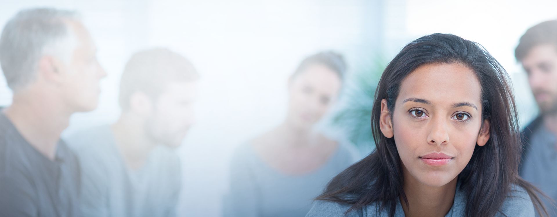 Woman with people blurred behind her